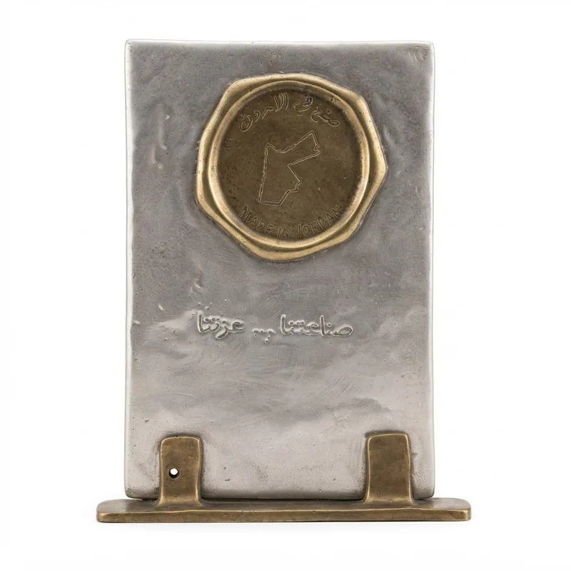 Cast metal shield on a brass stand, embossed with a wax-seal emblem of the map of Jordan reading "Made in Jordan", presented by the Head of the Jordanian Contractors Association.